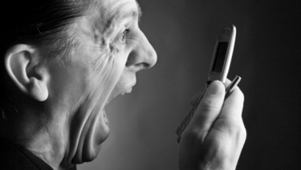 Man screaming at cell phone