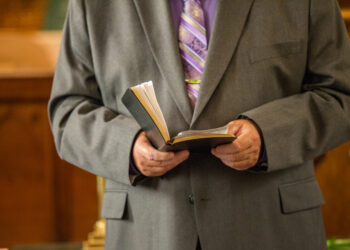 Wedding Pastor Reading from Bible in Church