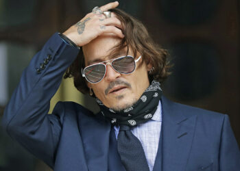 FILE  - In this Tuesday, July 14, 2020 file photo, American actor Johnny Depp gestures to the media as he arrives at the High Court in London. The UK High Court has ruled against Johnny Depp in his libel suit against the owner of the Sun newpaper over wife-beating allegation, it was reported on Monday, Nov. 2, 2020. (AP Photo/Matt Dunham, file)