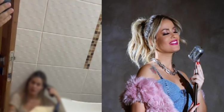 A cantora aparece sentada no chão do banheiro com uma arma apontada para a cabeça. Foto: Reprodução